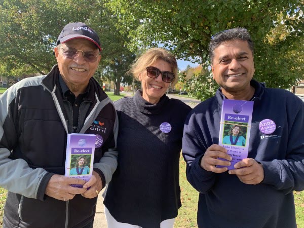 Anna Hopkins with two volunteers holding Re-elect Anna Hopkins brochures