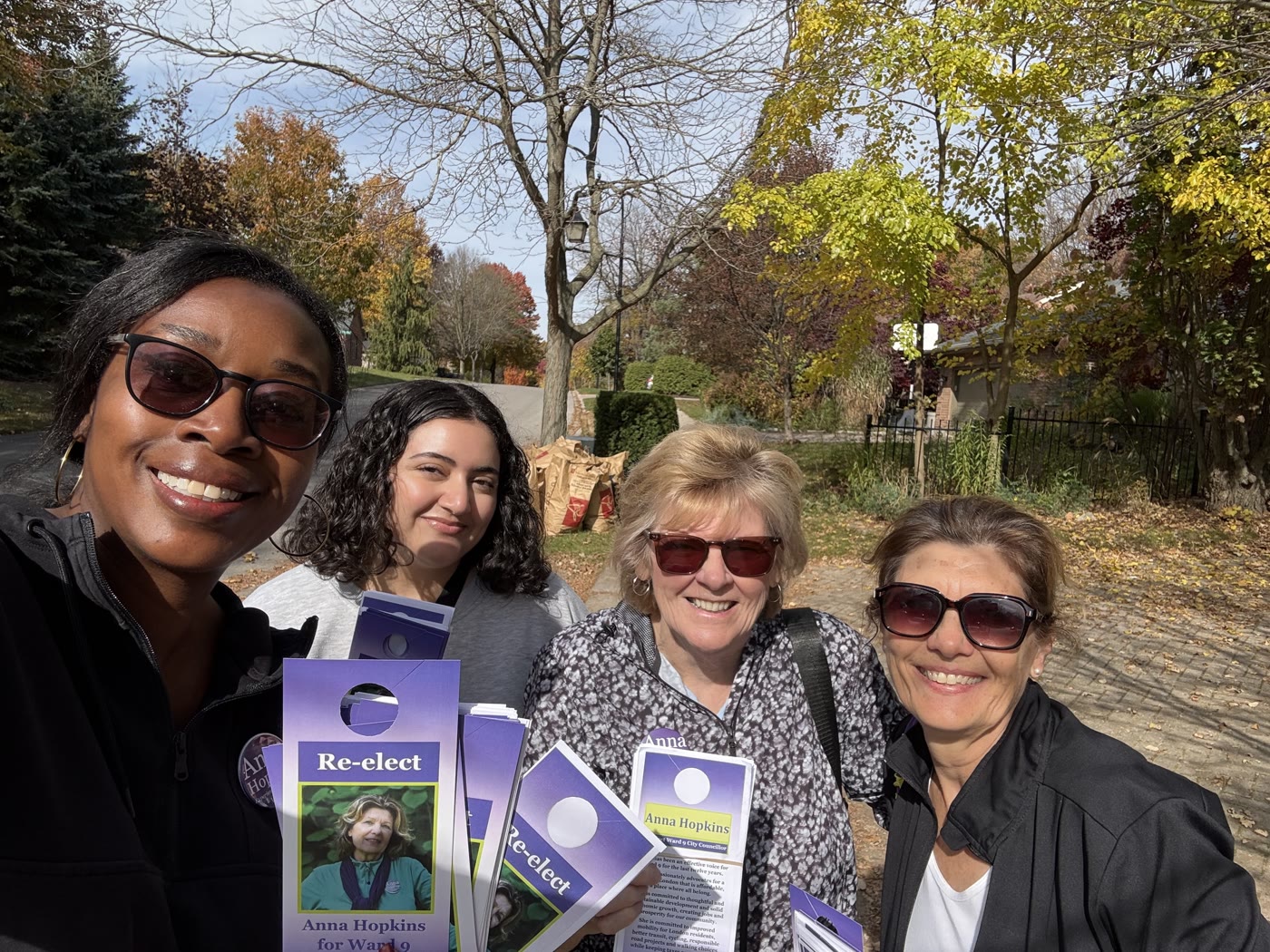 Anna Hopkins with volunteers holding Re-elect Anna Hopkins door hangers while canvassing in Ward 9