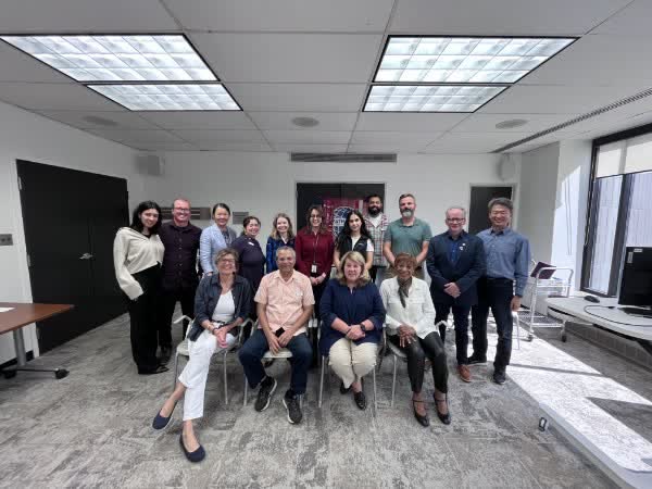 Anna Hopkins with colleagues at a committee meeting