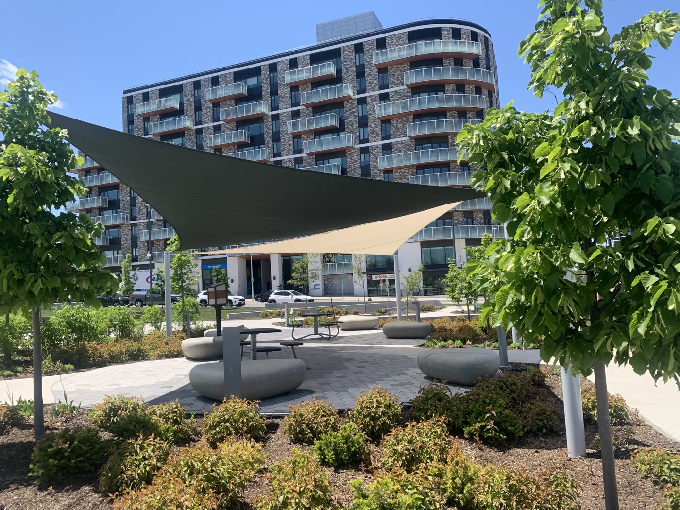 A modern park square beside condos in Riverbend