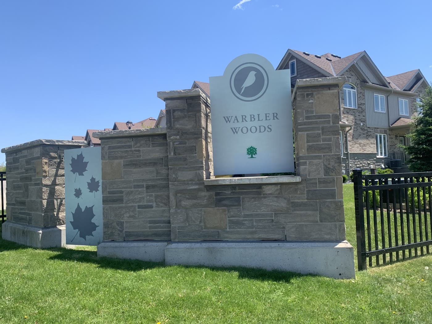 Warbler Woods neighbourhood stone entrance sign